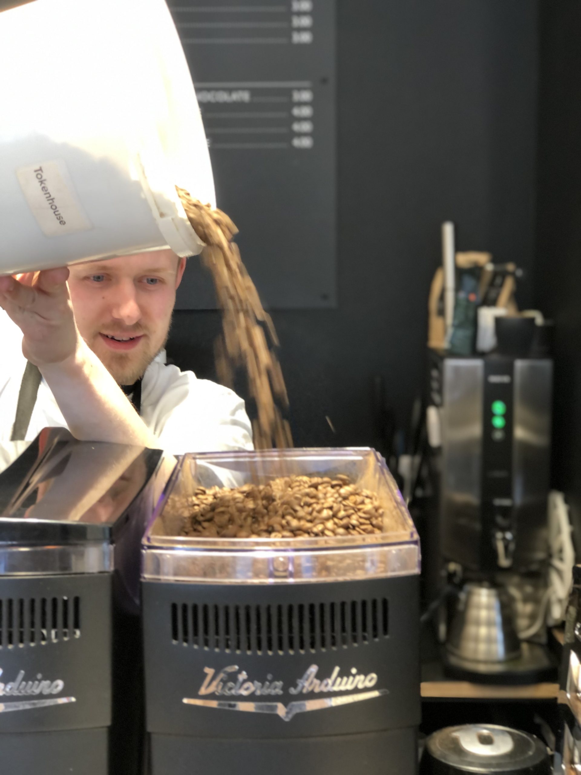 Barista pouring beans